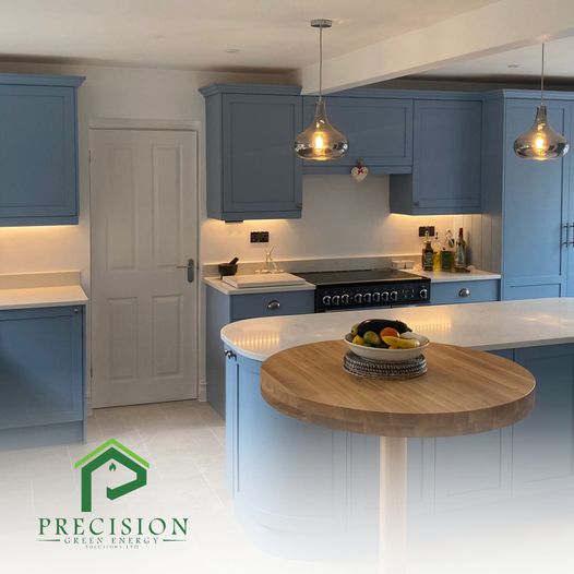 Blue fitted kitchen with pendant and under-cabinet lighting installed by Precision Green Energy